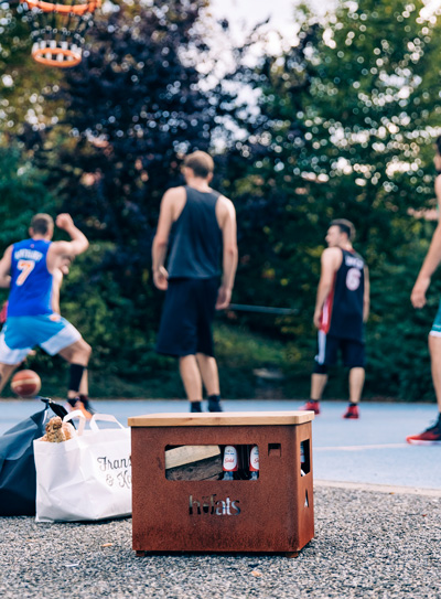 An inviting scene with a group of people playing a game of basketball, highlighted by the presence of the Beer Box Firebasket