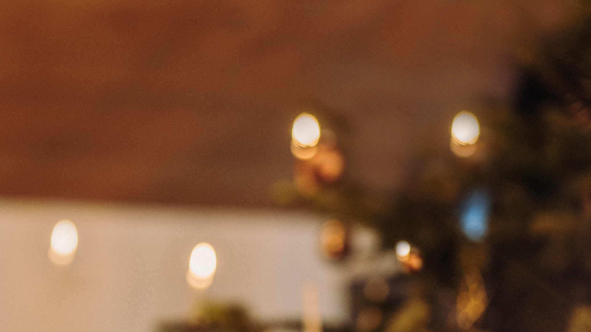A view of a small teddy bear sitting on a table, with the OVAL CANDLE Wall Mount silver.