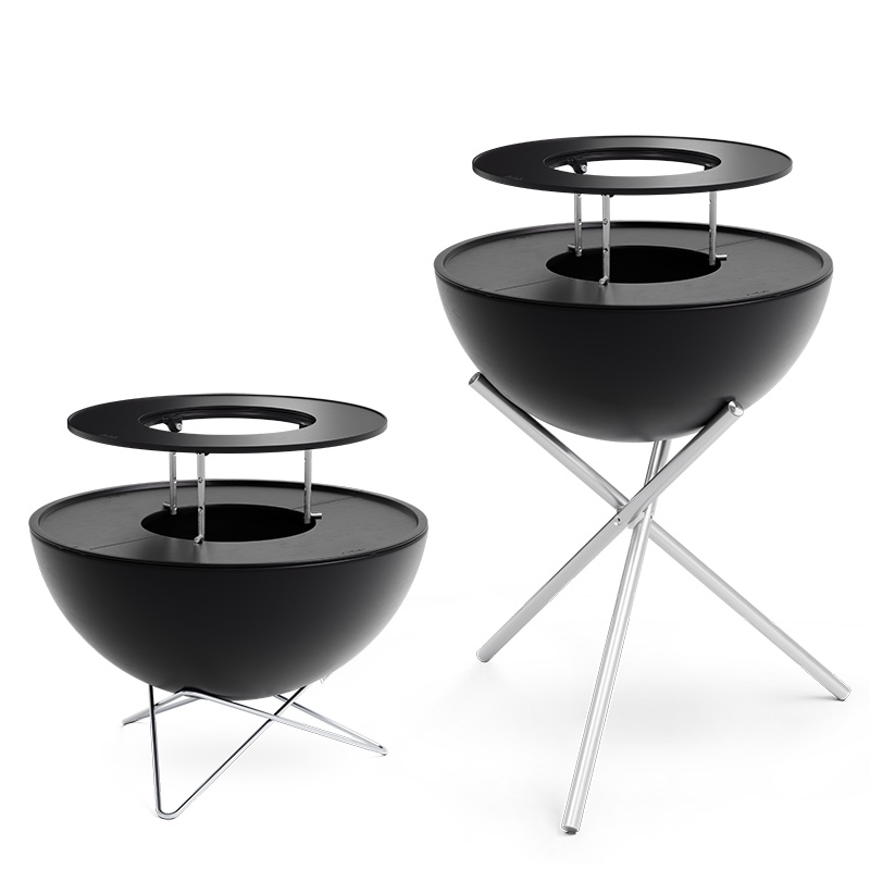 Two black metal fire bowls, enriched by the presence of the 00617 Bowl 70 Warming Ring, which merges design with utility.