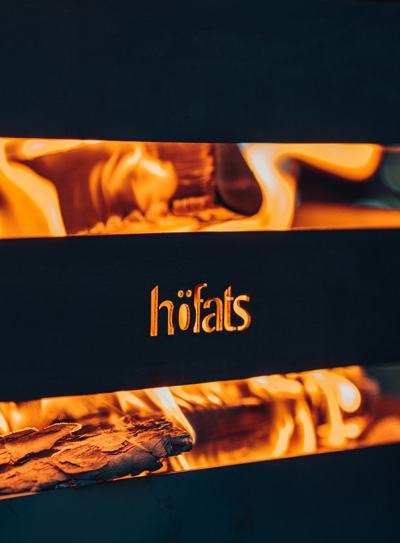 A view of a fire with the word hots on it, with the CRATE Fire Basket.