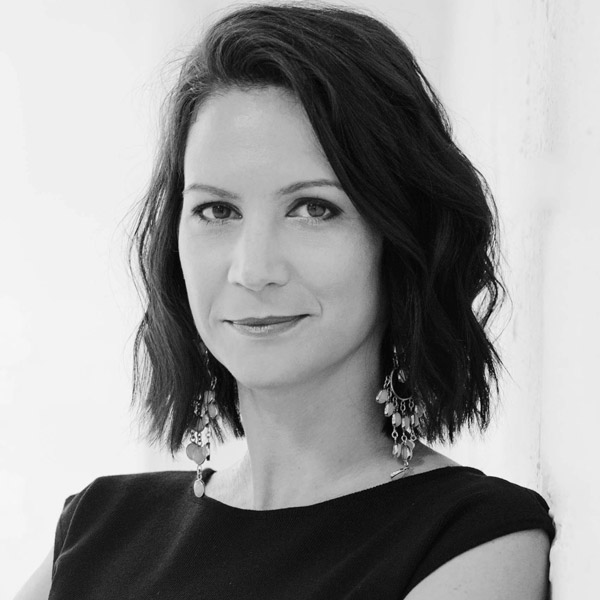 a woman with short hair and a black top.