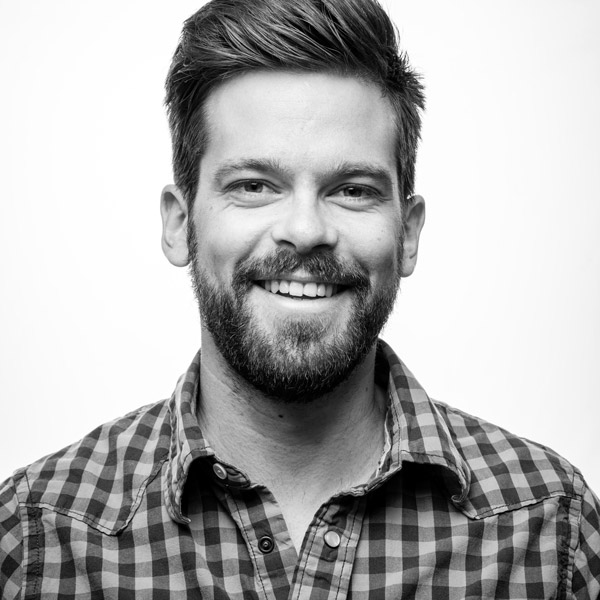 a man with a beard smiling at the camera.