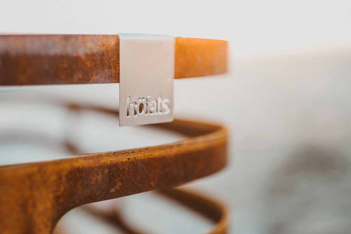 CUBE Fire Basket Corten Steel The Cube Firebasket rusty is shown in a closeup, creating a stylish and accessible visual.