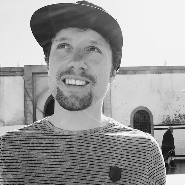 a man with a hat and striped shirt.