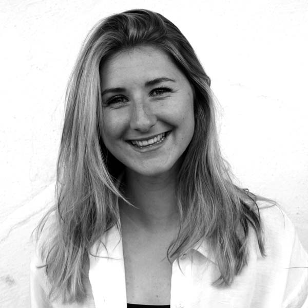 a woman with long hair and a white shirt.