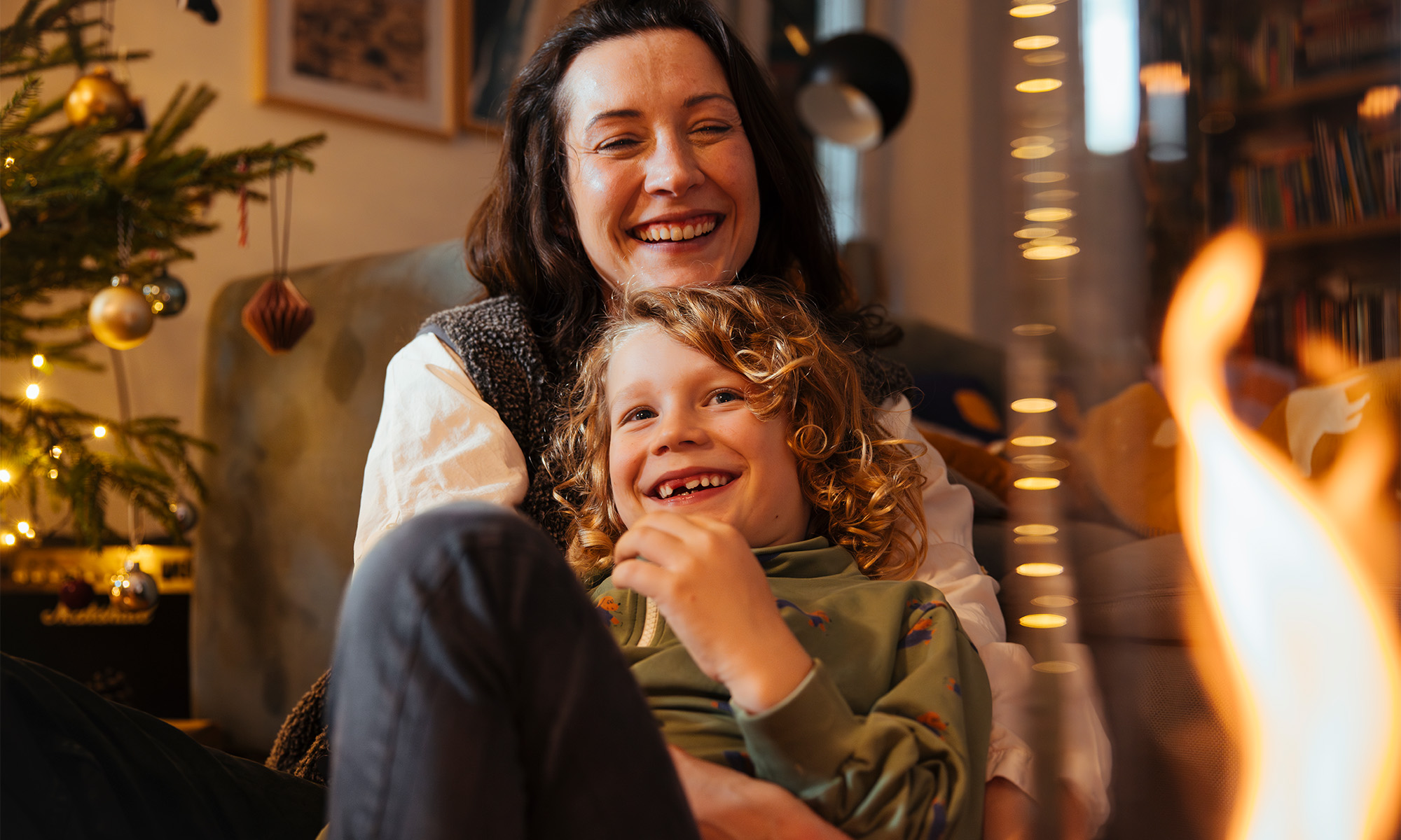 A depiction of a woman and a child sitting on a couch