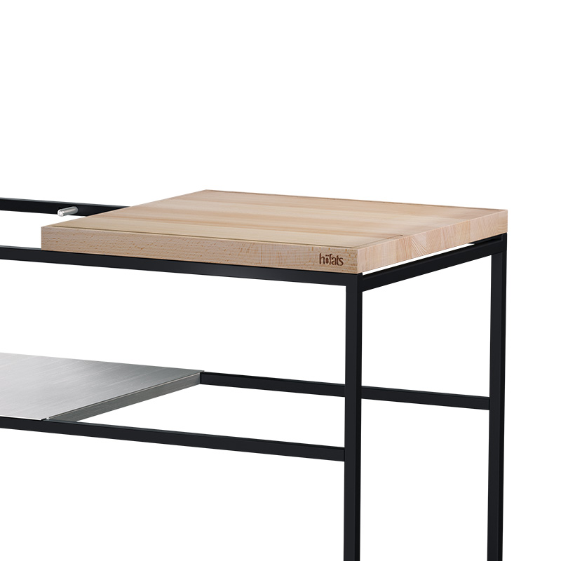 The photo presents a wooden table with a metal frame and a wooden top, with the FIRE KITCHEN Worktop.