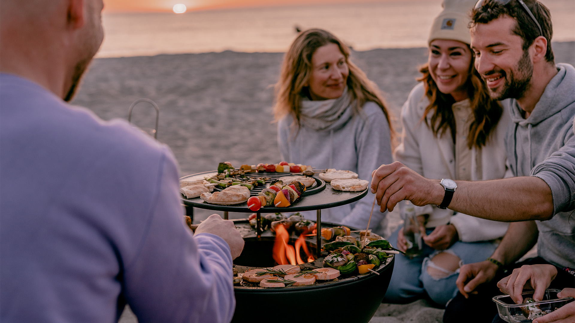 A view of a man serving food, with the BOWL 57 Warming Ring.