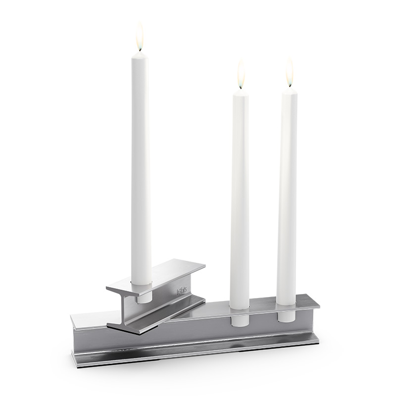 Illustrated is a pair of candles on a stand, with the HENRY METAL II Candleholder silver.
