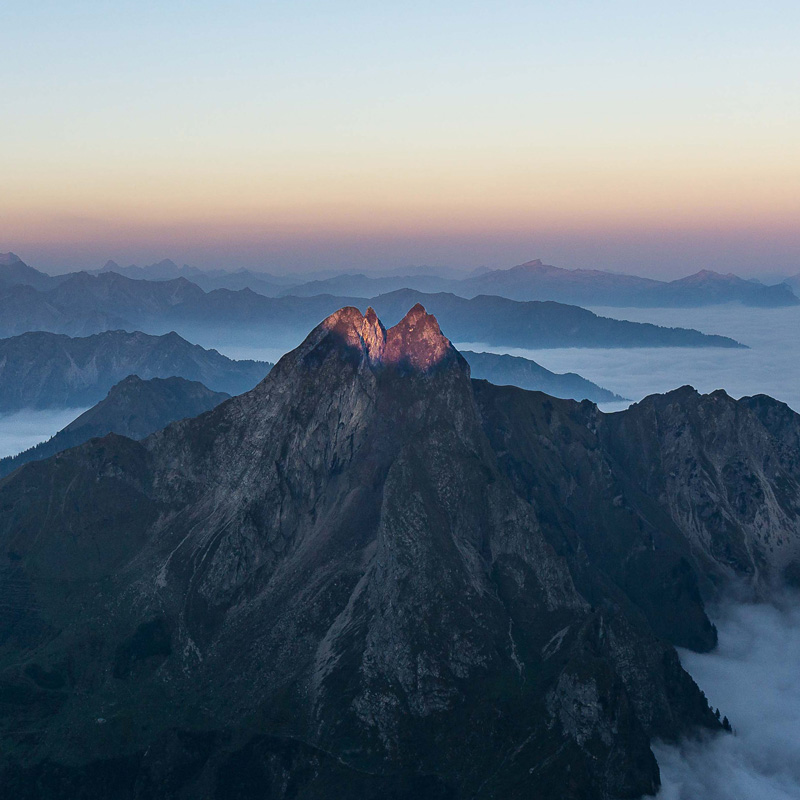 a mountain range with a few clouds.