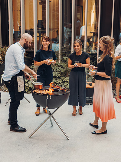 people standing around a fire pit.