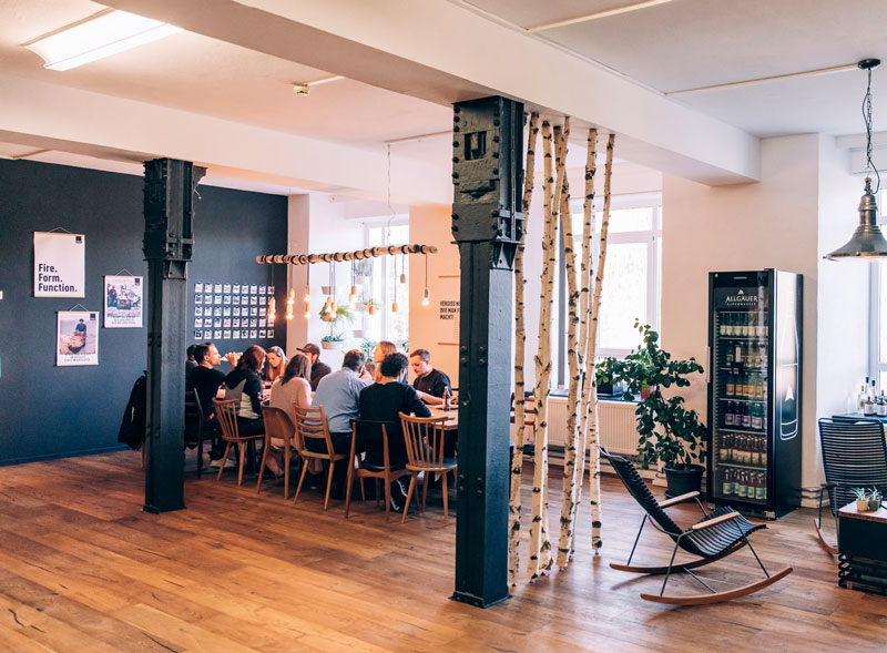 a group of people sitting at a table in a room.