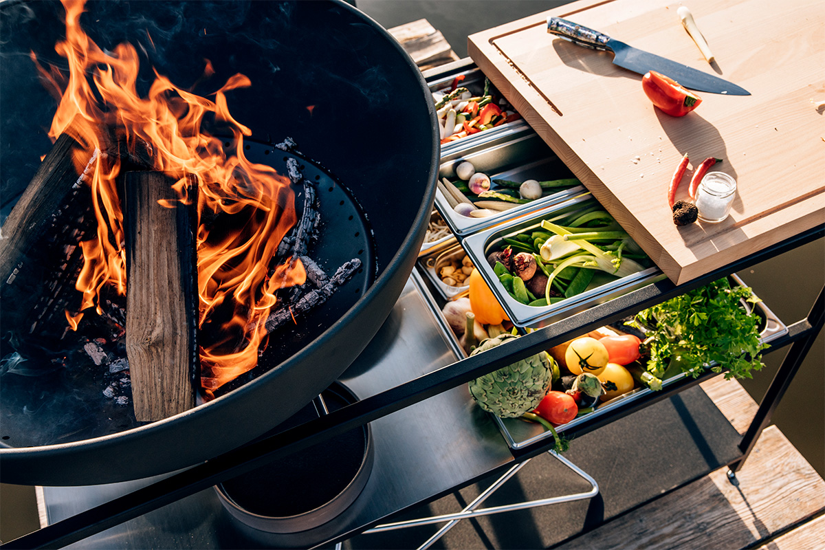 The 00764 FIRE KITCHEN Stainless Steel Container Set (5 pcs) is shown as a large pot of food on a table, creating a stylish and accessible visual.