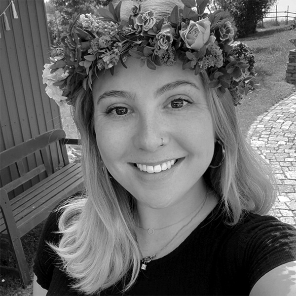 a woman standing on a bridge looking at the water