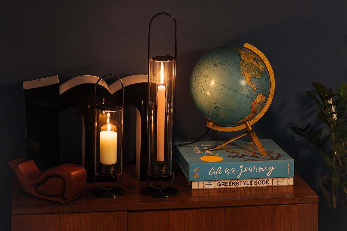 Scene showing a book on a table, where the 00274 Oval Candle 55 black stands out for its practical elegance.