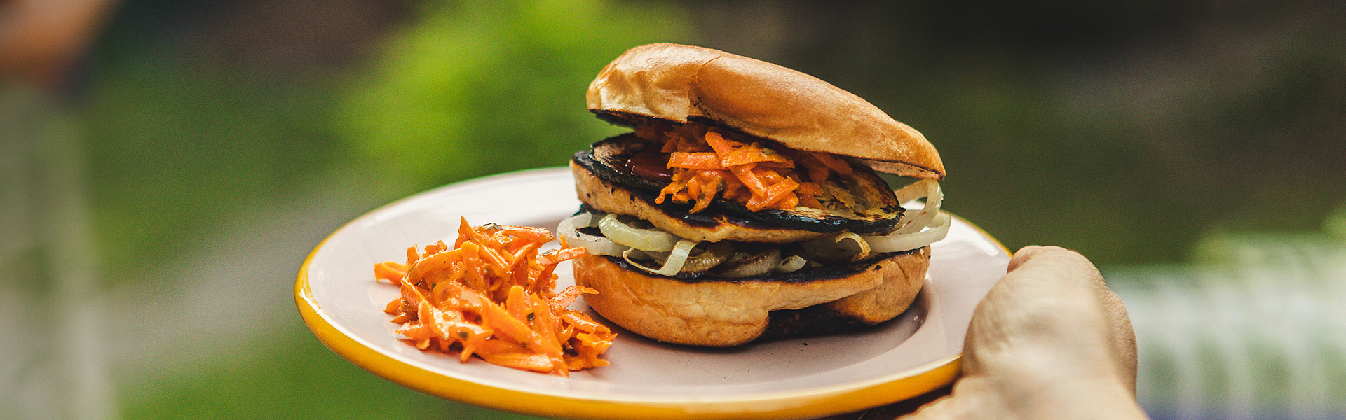 a hand holding a sandwich