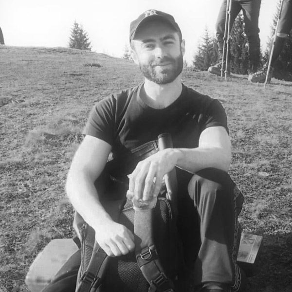 a man sitting on the ground with his feet crossed.