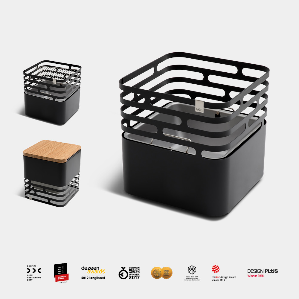 The photo presents a black box with a wooden lid and a wooden lid, with the LOGO CUBE Fire basket black.