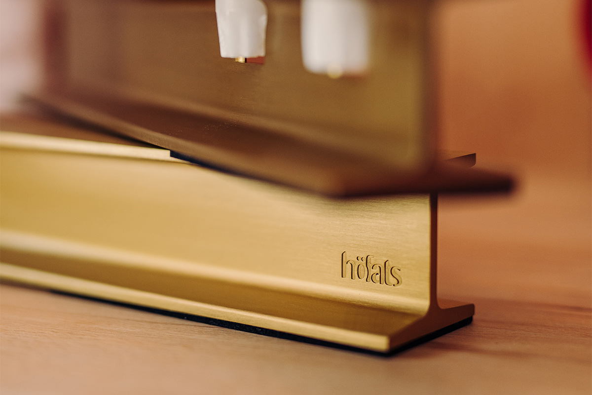 A close up of a golden candleholder on a table, with the 00662 Henry Metal II Gold adding a functional and elegant touch to the scene.