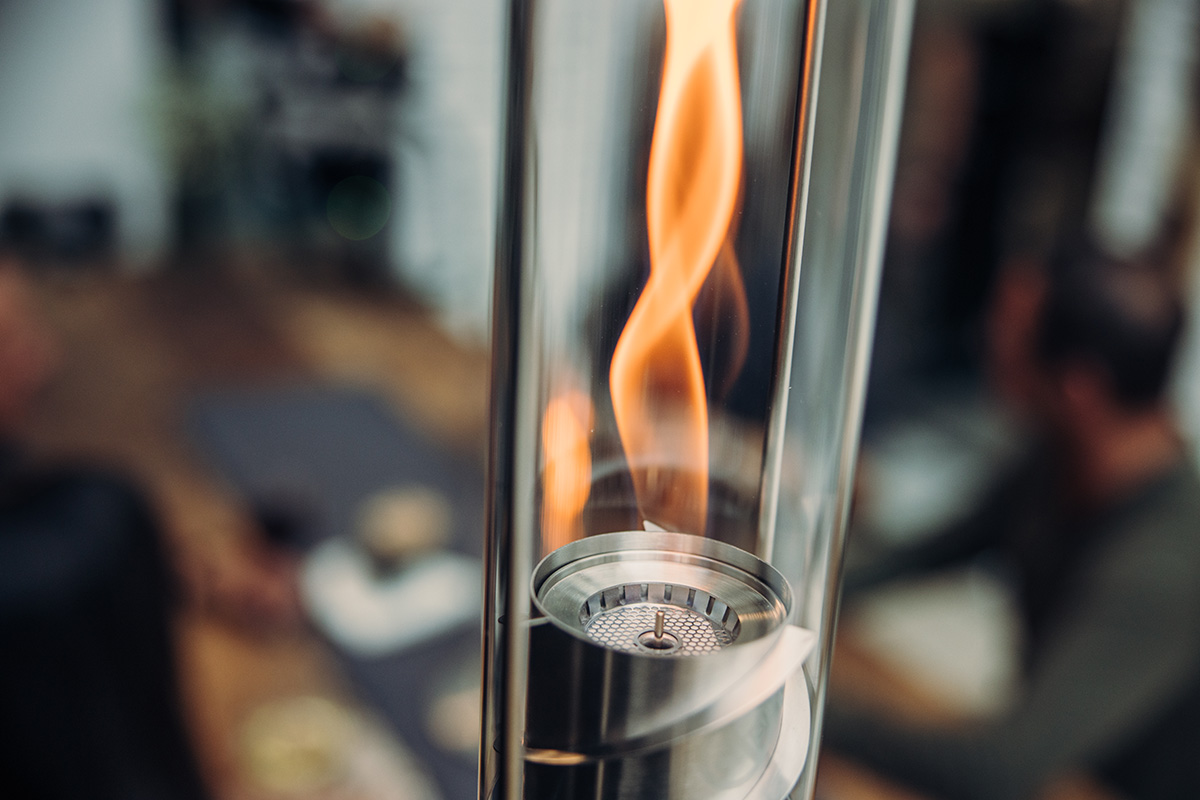 The Spin 900 Hanging Fire is shown as a glass with a fire inside of it, creating a stylish and accessible visual.