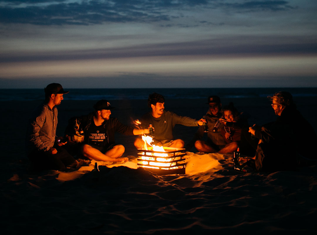 a group of people sitting around a fire, creating a stylish and accessible visual.