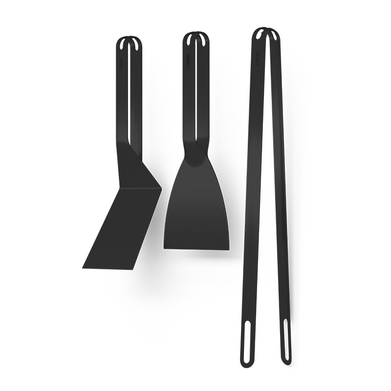 Scene showing a pair of black metal utensils with a spatula and a scraper, the 00878 Bbq Tool Set black stands out for its practical elegance.